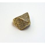 A 9CT GOLD GENTS RING, with pyramid shape design and encrusted with cubic zirconias to the tapered