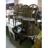 A PRIORY OAK GATE LEG TABLE, and four matching wheel back chairs (5)