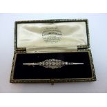 AN EDWARDIAN DIAMOND BROOCH, with graduated rose-cut diamonds and scalloped diamond surround, length