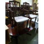 A MODERN MAHOGANY EXTENDING DINING TABLE, and six chairs, including two carvers and a matching
