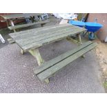 A LARGE WOODEN PICNIC BENCH