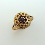 A VICTORIAN RING, the central circular amethyst with decorative scalloped surround to the two