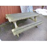 A LARGE WOODEN PICNIC BENCH