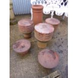 THREE TERRACOTTA CHIMNEY POT TOPS, a pair of smaller chimney pot tops and a chimney pot (6)