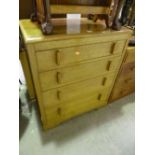 AN OAK CHEST OF FOUR DRAWERS