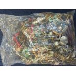 A BAG OF COSTUME JEWELLERY