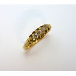 AN 18CT GOLD DIAMOND RING, with graduated rose cut diamonds to the tapered shank, hallmarks for