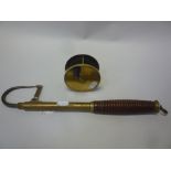 A BRASS 3 3/8 INCH FISHING REEL, and brass and wooden handled gaff