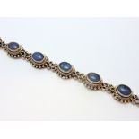 A BRACELET, comprising of oval shaped opal doublets, length 21cm