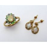 TWO ITEMS OF JEWELLERY, a 9ct gold opal cluster ring with an oval shape opal within a surround of