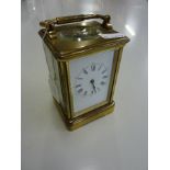 A BRASS CARRIAGE CLOCK, with key