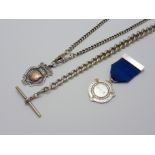 THREE ITEMS, to include a graduated silver albert chain, a silver chain with shield fob together