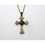 A 9CT GOLD DIAMOND AND SAPPHIRE CRUCIFIX PENDANT, with sapphire square shape centre and diamond