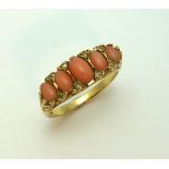A 9CT GOLD CORAL AND DIAMOND RING, the graduated coral with diamond accents to the fancy scrolling