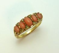 A 9CT GOLD CORAL AND DIAMOND RING, the graduated coral with diamond accents to the fancy scrolling