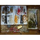 A LARGE BOX OF COSTUME JEWELLERY, with beaded necklaces, lighters and a pen