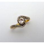 A DIAMOND RING, the old cut diamond to the bi-coloured twisted shank, estimated diamond weight 0.