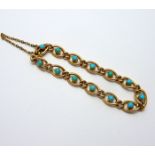 A VICTORIAN TURQUOISE BRACELET, each link with a circular turquoise cabachon to the concealed