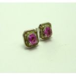 A PAIR OF PINK SAPPHIRE AND DIAMOND EARRINGS, of oval shape sapphires within a hexagonal shape