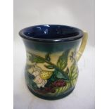 A BOXED MOORCROFT POTTERY MUG, 'Fruit Garden' pattern, impressed marks, dated 99, height 8.5cm