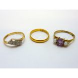 THREE RINGS, the first a 22ct gold plain band ring, an 18ct gold three stone ring together with a