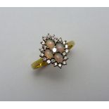 AN 18CT GOLD DIAMOND AND OPAL CLUSTER RING, with central brilliant cut diamond to four oval opals