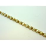 A PEARL NECKLACE, the pearls with gold coloured spacers to the oval shape clasp, stamped 9ct, length