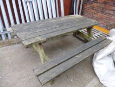 A LARGE WOODEN PICNIC BENCH