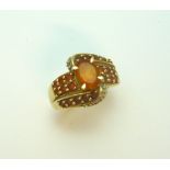 A 9CT GOLD DRESS RING, with oval citrine within two abstract citrine bands, hallmarks for