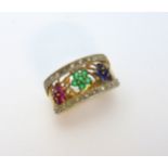 A 9CT GOLD DRESS RING, designed as three flowers within diamond boarders, to include emerald,