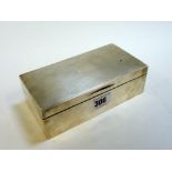 A SILVER CIGARETTE BOX, Birmingham 1947, rectangular shape with engine turned top and walnut lining,