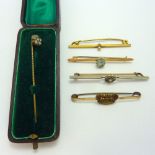 A SELECTION OF BROOCHES, and a stick pin (5)