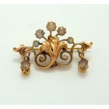 AN ANTIQUE ROSE GOLD BROOCH, stamped 585, one stone deficient