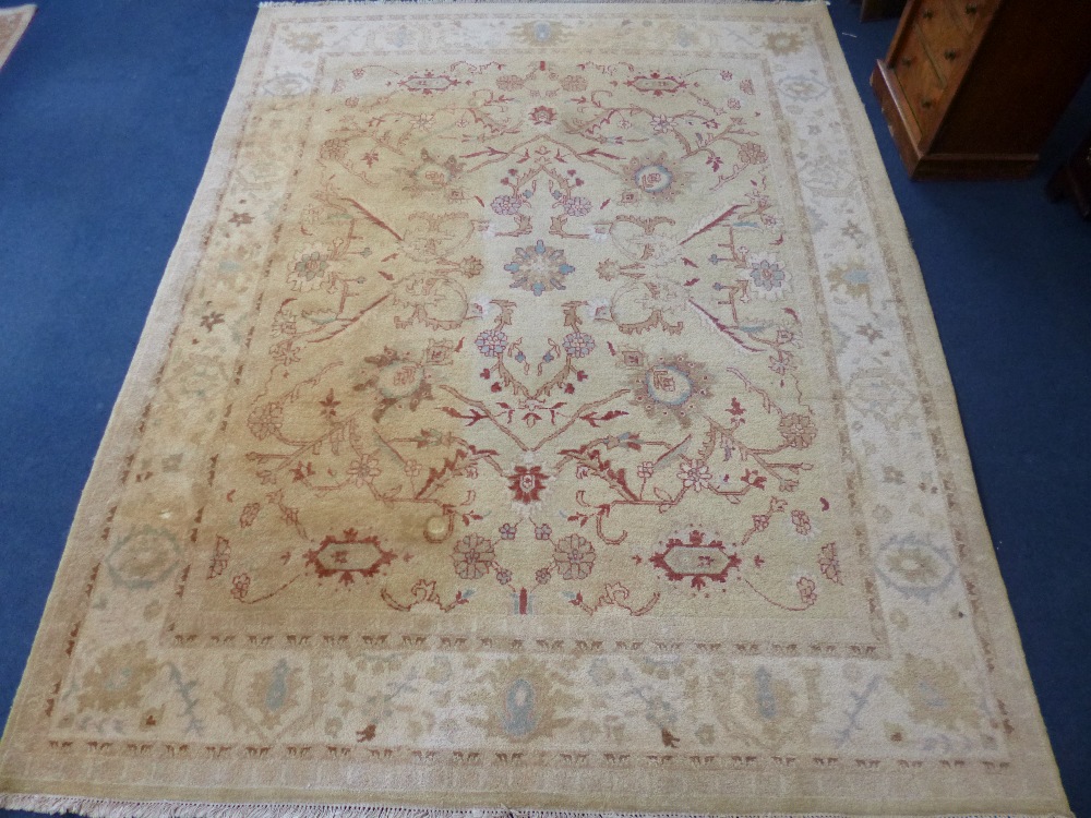 AN INDIAN 100% WOOL PILE HAND KNOTTED OAKMEAL GROUND CARPET, approximate size 305cm x 244cm, G H