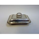 AN EDWARDIAN SILVER COVERED SERVING DISH, Elkington, Birmingham 1922, of oblong shape with gadrooned