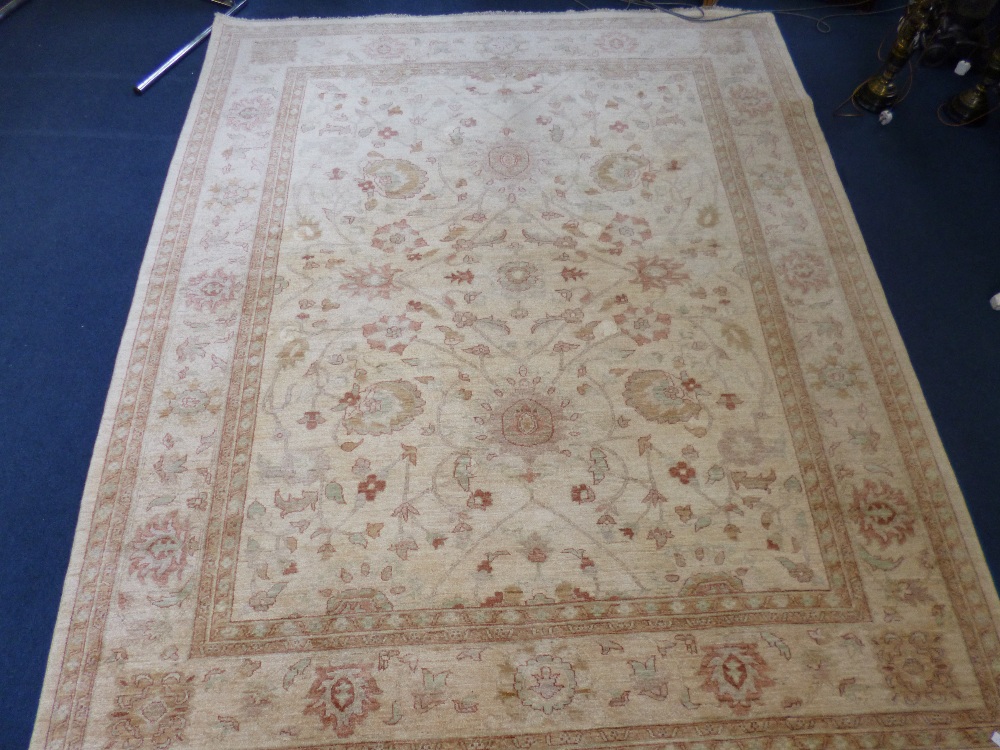AN AFGHAN 100% WOOL PILE HAND KNOTTED OATMEAL GROUND CARPET, approximate size 305cm x 244cm, G.H.