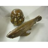 A BRASS FISH AND NOVELTY ORIENTAL HEAD PAPERWEIGHT, (2)