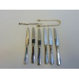 A GROUP OF SILVER, to include George III sugar tongs, six modern dessert knives and a plated