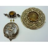 THREE ITEMS, to include two circular shape brooches and a further cap badge