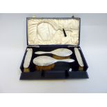 A CASED SILVER MOUNTED DRESSING TABLE SET, Birmingham 1928, with engine turned decoration,