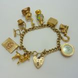 A 9CT GOLD CHARM BRACELET, comprising of nine 9ct gold novelty charms and one other to the curb link