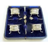 A CASED SILVER CONDIMENT SET, Birmingham 1906, comprising four mustard pots and spoons, velour and