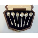 A CASED SET OF SIX ART DECO COFFEE SPOONS. K & L, Birmingham 1934, with canted facet handles to a