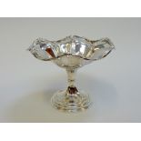 AN EDWARDIAN SILVER TAZZA, Sheffield 1912, of lobed floret form with flower moulded rim and foot,