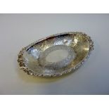 A LATE VICTORIAN ELECTROPLATED OVAL SERVING DISH, the rim moulded with flowers and foliage, the