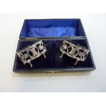 A CASED PAIR OF SILVER TABLE SALTS, Arthur Cook, Birmingham 1901, of lobed ovoid shape, open
