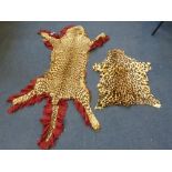 A CHEETAH SKIN RUG, (Acinonyx Jubatus), with head and claws, mounted with glass eyes and on red felt