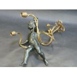 A PATINATED SPELTER AND GILT METAL FIGURAL WALL SCONCE, modelled as a cherub balancing on wrythen