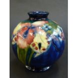 A MOORCROFT ORCHIDS VASE, circa 1938-40, of globe shape with everted rim, decorated with flowers and