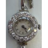 A LADIES ART DECO WATCH, circa 1920, the circular dial within a surround of old-cut diamonds,